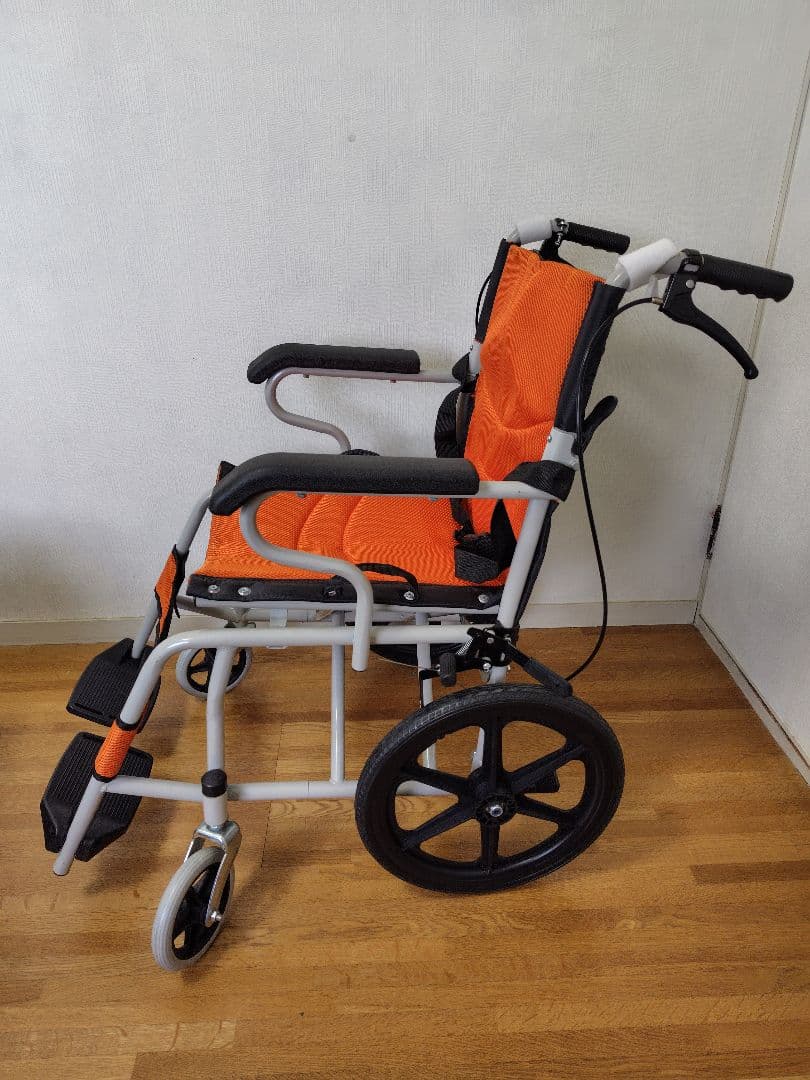 オレンジの折りたたみ式介助用車椅子